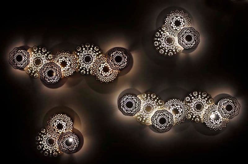 Sculptural perforated sphere wall lights